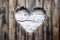 Wooden background with heart-shaped hole, rustic wood texture. Farmhouse shabby chic style