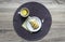 On a wooden background napkin round wicker tea cup lemon saucer puff croissant breakfast