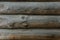 Wooden background of an old fashioned rustic round log wall