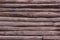 Wooden background. Old log wall. Solid wooden wall from weathered logs