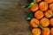 Wooden background with orange clementine