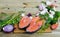 Wooden background with salmon steaks, vegetables, mushrooms