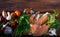 Wooden background with salmon steaks, vegetables, mushrooms