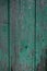 Wooden background. Shabby board. Peeling green paint.