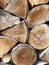 Wooden background. Side view of a pile of firewood.