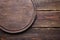 Wooden background template - round cutting board on brown planks