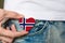 Wooden badge with Norway flag in the shape of a heart in a man`s hand.