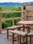 Wooden balcony and bench at cafe with scenic view of mountain and forest in Kyoto, Japan