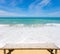 Wooden bamboo sunbeds on beautiful beach and sea scenery background.