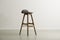 Wooden bar stool with a molded leather seat