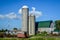 Wooden Barn with Green Roof and Two Silos