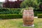 Wooden barrel between clipped bushes, park