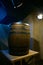Wooden barrel on a dark background, in a workshop, in an old room. production of barrels for cognac and wine, in a low