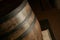 Wooden barrel on a dark background, in a workshop, in an old room. production of barrels for cognac and wine, in a low