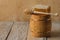 Wooden barrel with honey, honey in a honeycomb with a wooden spoon and drops on the table