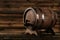 Wooden barrel with iron rings on a brown wooden background