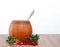 Wooden barrel with spoon and lingonberries on a white background