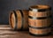 Wooden barrels against grey background, space for text