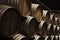 Wooden barrels in dark wine factory hall