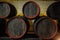 wooden barrels inside the underground tunnels of a winery