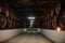 Wooden barrels inside the underground tunnels of a winery