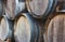 Wooden barrels stacked in a pile with vintage wine