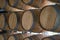Wooden barrels stand on top of each other, wine storage, part of the interior, the structure of the tree.