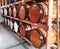 Wooden barrels for storage of alcoholic beverages grouped in a cellar