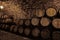 Wooden barrels with whiskey near stone wall