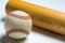 Wooden baseball bat and ball on white