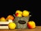 Wooden basket and crate with fresh colorful apples on dark background