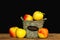 Wooden basket with fresh colorful apples on dark background