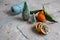 Wooden Basket Mandarine with Leaves and Lights, Tangerine Orange on Gray Table Background Christmas New Year Decors