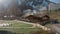 Wooden bathhouse at countryside city surrounded by mountain snowy peaks aerial view