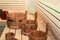 Wooden Bathhouse with scoop and tub tools close up. Wooden sauna interior with equipment.