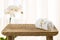 Wooden bathroom table, spa towel and orchid flower with copyspace