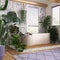 Wooden bathroom in white and purple tones with freestanding bathtub. Windows with venetian blinds. Biophilic concept, many