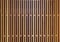 Wooden battens vertical texture, brown color.