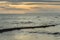 Wooden beach groin semi submerged by tide at sunset. British Col