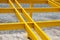 Wooden beams painted yellow form cells. Unusual background of cells formed by wooden floors.