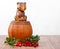 Wooden bear on small barrel with bunch of lingonberries