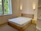 Wooden bed with white mattress
