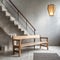 Wooden bench against grey wall and staircase. Scandinavian, rustic farmhouse interior design of modern entryway