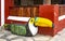 Wooden bench carved into a toucan bird shape sitting on mosiac sidewalk against bambo and stucco wall in Mexico