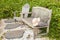 Wooden bench and chair with a hat left on the arm