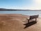 Wooden bench on coast at the beach.