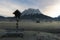 Wooden bench and cross on a frosty meadow