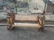 Wooden bench decorated with lions heads in the park.