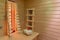 Wooden bench in an infrared cabin with a white towel and blossom