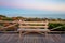 Wooden bench with its back to the sea on Cabopino beach, Marbella, Malaga, with the sea in the background